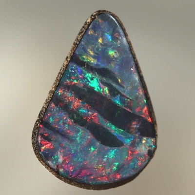SOLID BOULDER OPAL Bright red and green surround black opal bands 